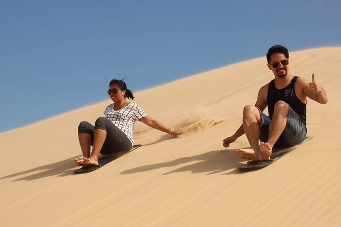 couples sandboarding